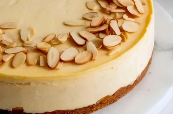 Slice of Almond Amaretto Cheesecake topped with almonds