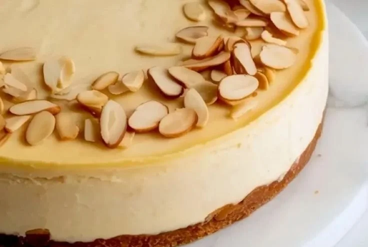 Delicious slice of Almond Amaretto Cheesecake with almond garnish