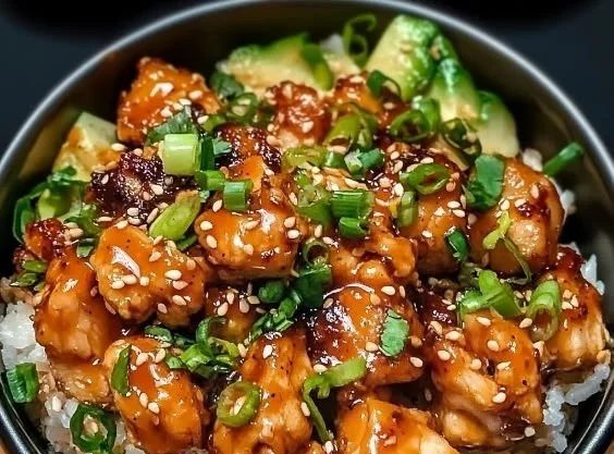 Delicious Bang Bang Chicken Bowl garnished with fresh vegetables and spicy sauce.