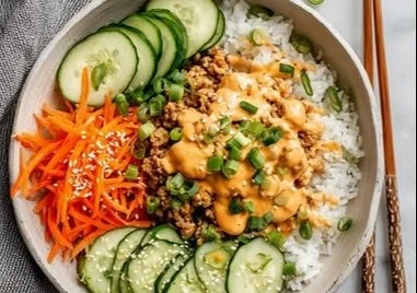 Delicious Bang Bang Ground Turkey Rice Bowls garnished with fresh herbs.