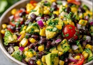Black bean and corn avocado salad with lime vinaigrette in a bowl
