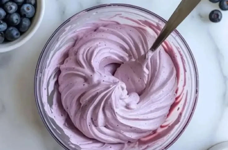 Delicious blueberry cream cheese frosting on a cupcake