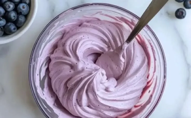 Delicious blueberry cream cheese frosting on a cupcake