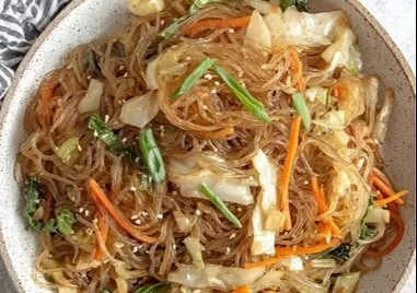 Cabbage noodles stir-fry with glass noodles and colorful vegetables on a plate