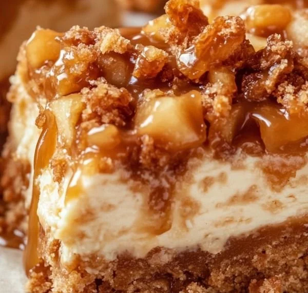Delicious caramel apple cheesecake bars on a white plate