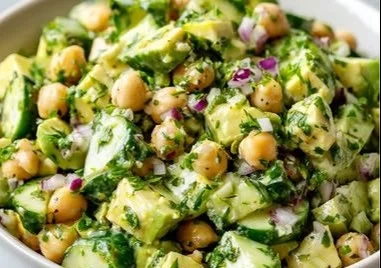 Chickpea avocado salad with cucumber and lemon dressing in a bowl