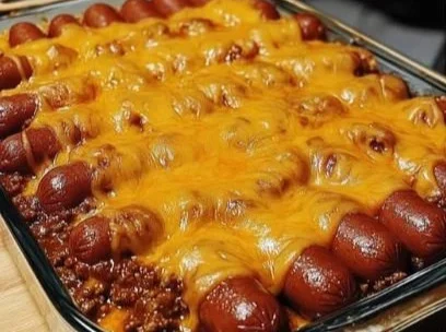 Delicious chili cheese dogs topped with cheese and chili in a bun