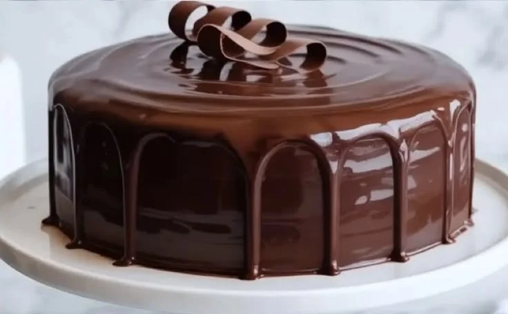 Delicious chocolate cake with sour cream frosting and chocolate decoration