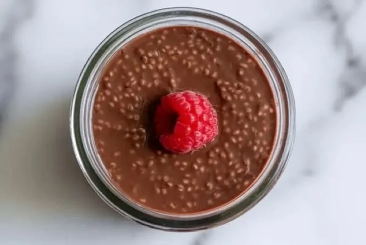 Delicious Chocolate Chia Pudding in a bowl topped with berries and mint