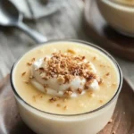Delicious bowl of homemade coconut pudding garnished with coconut flakes