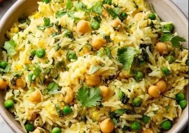 Bowl of coconut rice with chickpeas and green peas