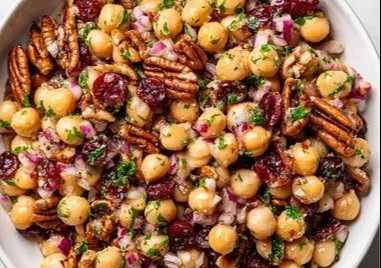 A vibrant bowl of Cranberry Pecan Chickpea Salad with colorful ingredients.