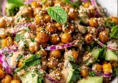 Crispy chickpeas served with cucumber tahini salad in a bowl