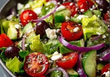 Bowl of fresh Italian salad with tomatoes, olives, and mozzarella
