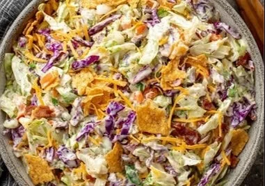 Delicious bowl of Frito Cowboy Cabbage topped with crispy Fritos and cheese