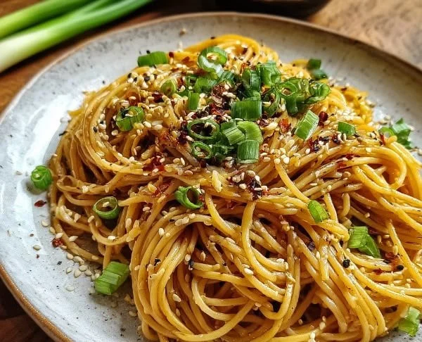 Delicious garlic sesame noodles served in a bowl with sesame seeds on top