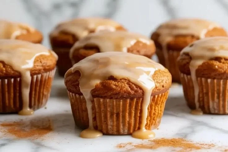 Delicious gingerbread muffins topped with a dusting of powdered sugar