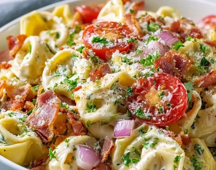 Colorful bowl of Grinder Tortellini Salad with fresh ingredients
