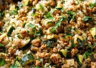 Ground chicken zucchini rice skillet served in a colorful dish.