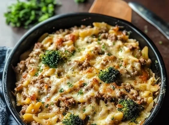 Ground turkey and orzo dish served in a bowl with vegetables and herbs.