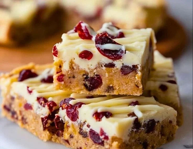 Homemade soft Starbucks Cranberry Bliss Bars with cream cheese frosting and cranberries