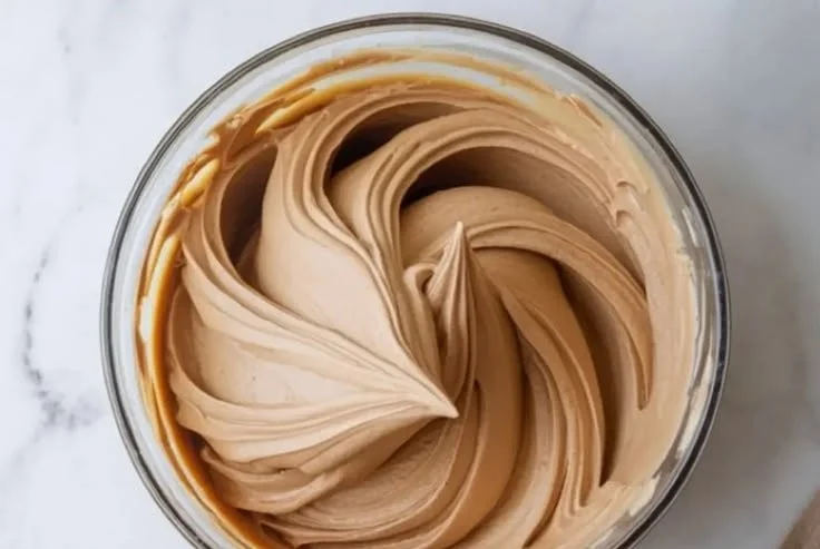 A delicious slice of Kahlua Buttercream Cake showcasing rich frosting and coffee flavor.