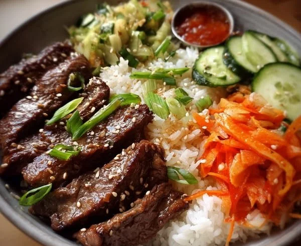 Korean BBQ steak bowl with grilled meat, rice, and vegetables