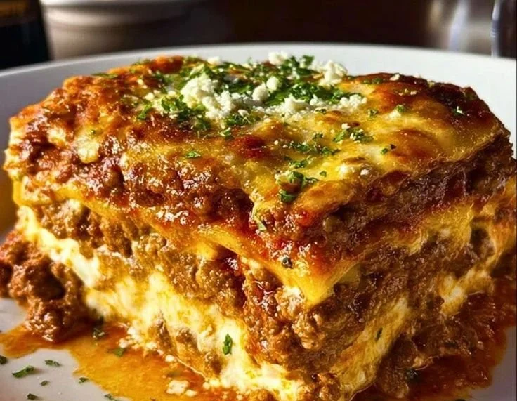 Delicious Maggiano-Style Lasagna topped with cheese and herbs