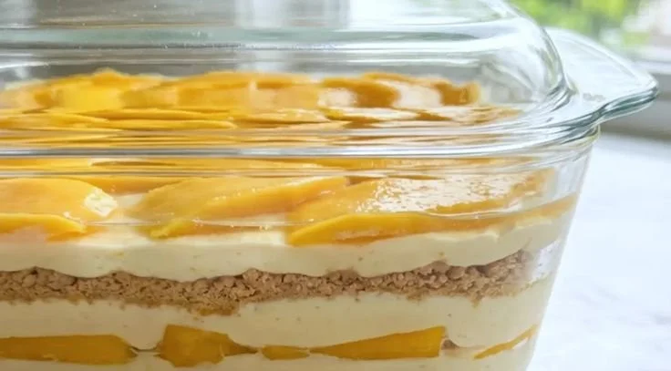 Delicious Mango Float layered dessert with ripe mangoes and whipped cream