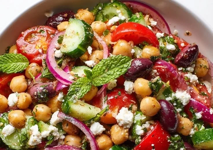 Colorful Mediterranean chickpea salad with fresh vegetables and herbs
