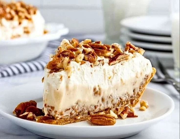 Delicious pecan cream pie with whipped cream and pecan topping