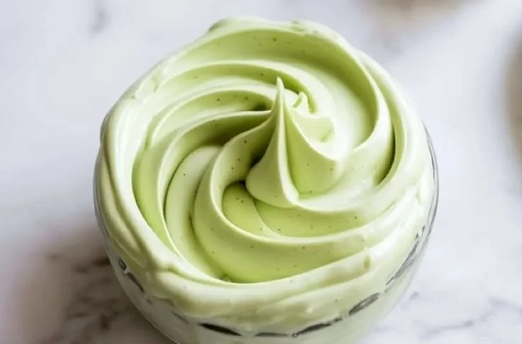 Pistachio mascarpone frosting spread on a delicious cake