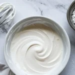 Delicious powdered sugar frosting on a chocolate cupcake
