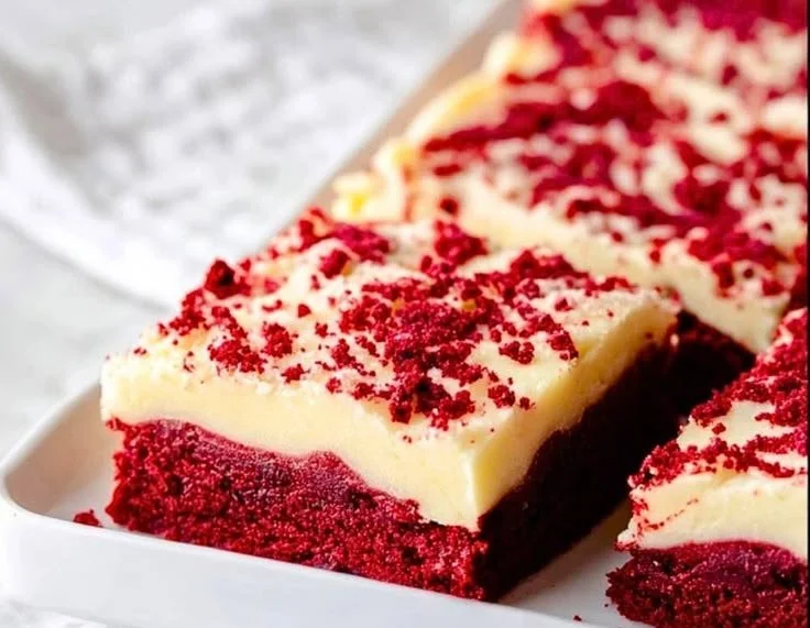 Delicious Red Velvet Cookie Bars served on a white plate with a festive background.