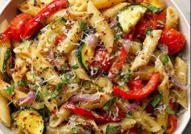 Delicious roasted vegetable pasta served in a bowl with fresh herbs