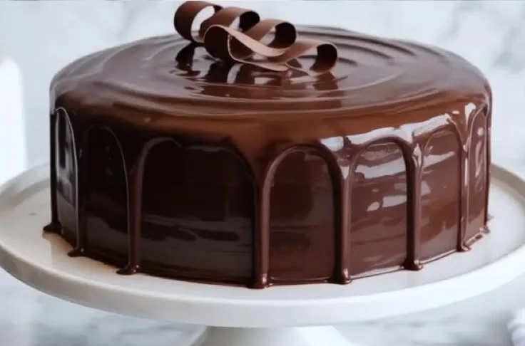 Delicious sour cream chocolate cake topped with rich frosting