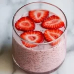 Bowl of Strawberry Chia Seed Pudding topped with fresh strawberries and mint