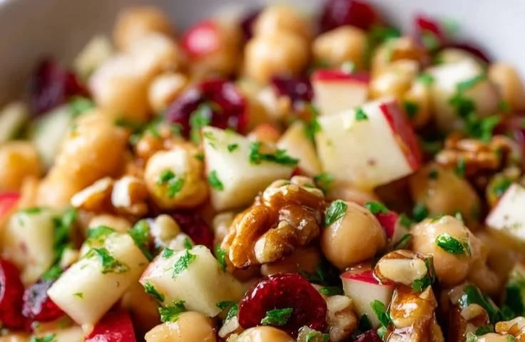 Summer chickpea salad with apple and cranberries served in a bowl.