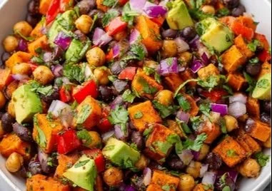 Colorful sweet potato salad with black beans and chickpeas in a bowl