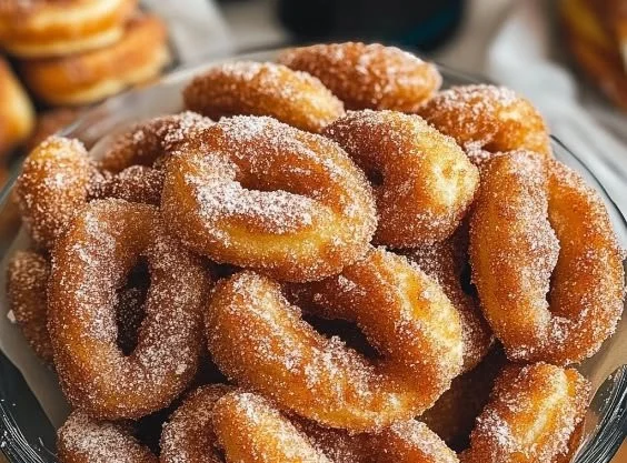 Twisted cinnamon sugar donuts freshly baked and coated with sweet cinnamon sugar