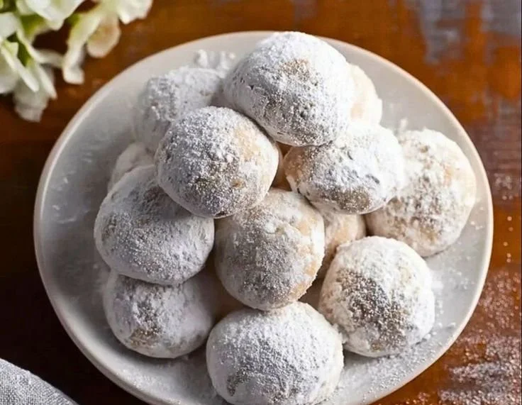 Plate of Vegan Russian Tea Cakes dusted with powdered sugar