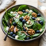 Fresh Blueberry Spinach Salad with berries, nuts, and dressing