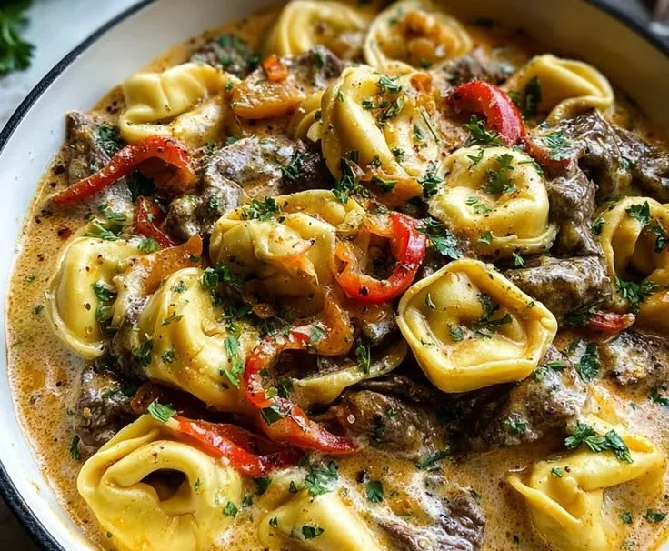Cheesesteak Tortellini served in creamy provolone sauce