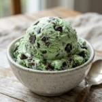Delicious bowl of Mint Chocolate Chip Ice Cream with chocolate chips and mint leaves