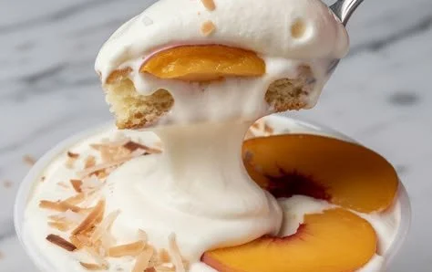 Delicious Peach Coconut Shortcake topped with fresh peaches and coconut cream