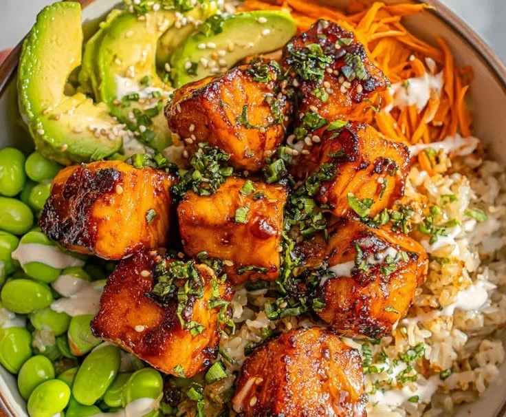 Salmon Teriyaki Bowl with vegetables and rice, featuring glazed salmon fillet.