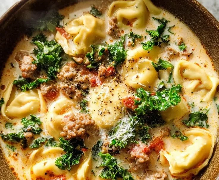 Bowl of Sausage Tortellini Soup with fresh herbs and vegetables